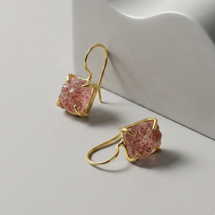Gold plated hook earrings with strawberry Quartz pink stone on a light grey background