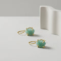 Pair of earrings with raw Amazonite gemstones a on a light grey background
