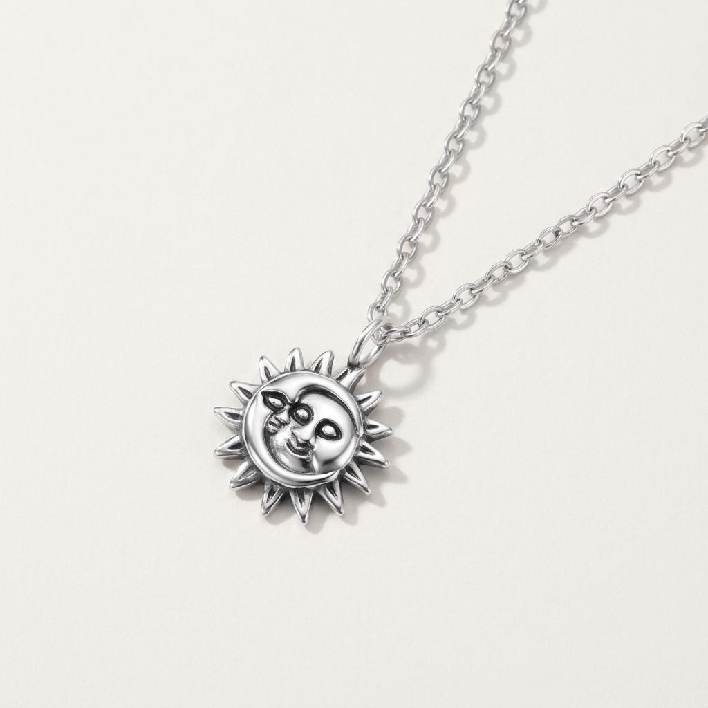 Close-up detail of sun and moon necklace